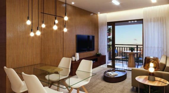 Imagem da sala de estar do PLENO Itaigara, mostrando decoração moderna, amplas janelas e acabamento sofisticado.