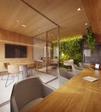Espaço coworking moderno e iluminado no HORIZON Jaguaribe, com mesas de trabalho, cadeiras ergonômicas, plantas decorativas e amplas janelas.