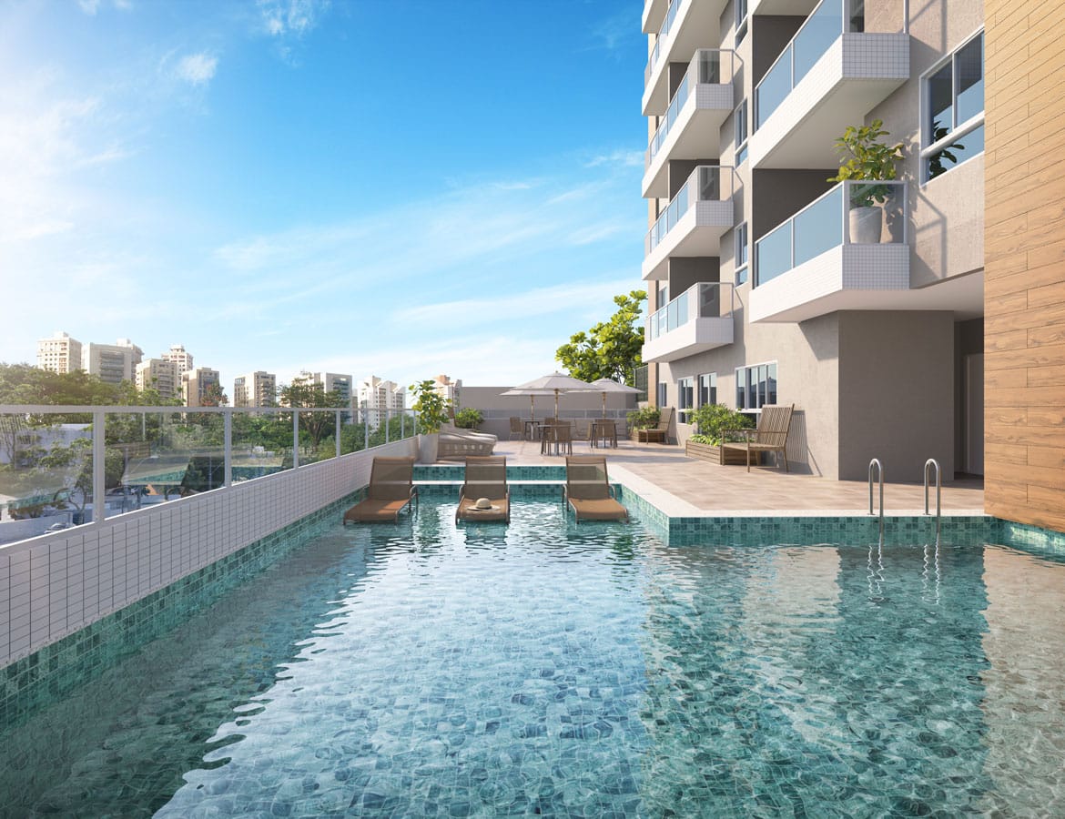 Perspectiva da área de lazer do Residencial Barcelona Home & Living com uma piscina de azulejos azuis, cercada por espreguiçadeiras e com vista para a cidade.