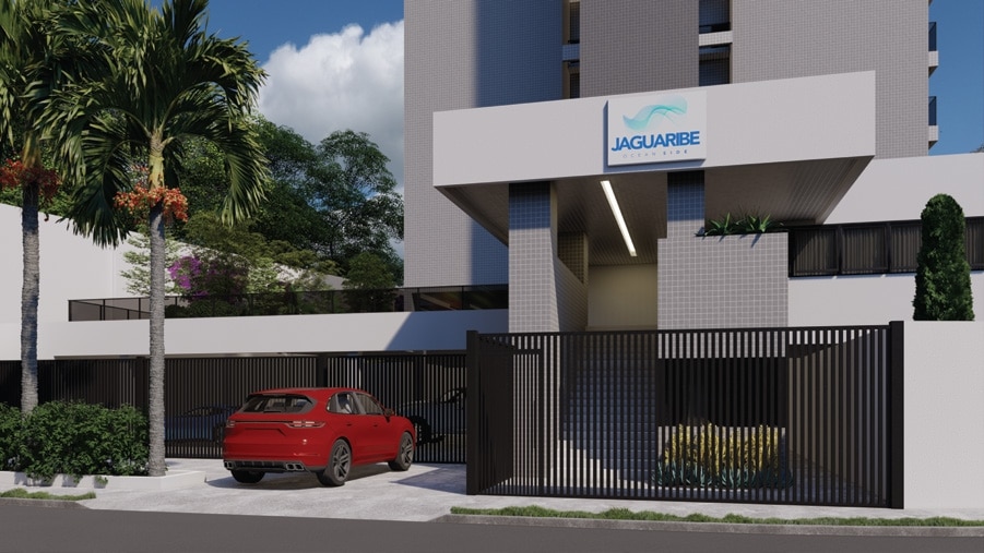 Entrada principal do edifício Jaguaribe OCEAN SIDE com portões elegantes, um carro vermelho à frente, e paisagismo tropical complementando sua arquitetura moderna.