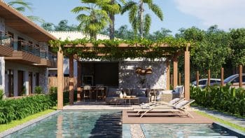 Imagem do espaço gourmet no Villa dos Coqueiros, com mobiliário confortável sob pergolado de madeira e vistas para a piscina.
