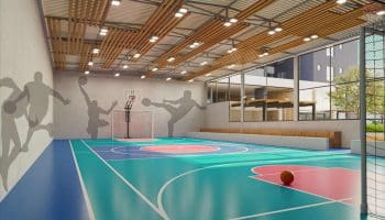 Ginásio poliesportivo do Villaggio Jardins, com quadra de basquete e futsal, iluminação moderna e arquibancada.