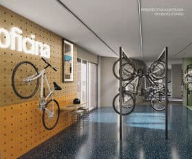 Bicicletário do Terrazza Balena, com suportes verticais para bicicletas, parede decorativa com ferramentas e bancada de manutenção, em ambiente iluminado e organizado.