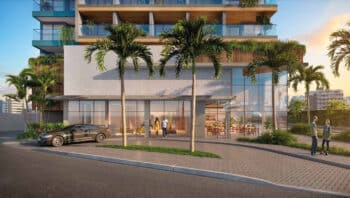 Porte cochère do Ocean Breeze, com arquitetura moderna, área de desembarque elegante, cercada por paisagismo tropical e fachada sofisticada.