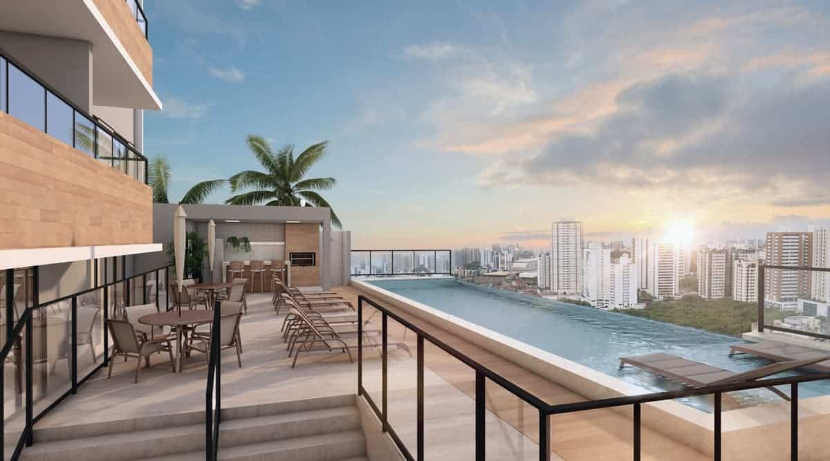 Imagem do rooftop do Imbuí Class, com piscina de borda infinita, área gourmet e espreguiçadeiras, oferecendo uma vista deslumbrante da cidade de Salvador.