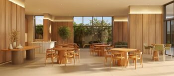 Salão de festas do Elleve Horto com mesas redondas de madeira, cadeiras de design contemporâneo, decoração minimalista e iluminação natural