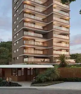Fachada térrea do Elleve Horto com portaria moderna, controle de acesso, cercado paisagístico e torre ao fundo durante o entardecer