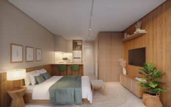 Apartamento studio do ZN Itacim com decoração minimalista, cama de casal, bancada com banquetas verdes, armários planejados e iluminação suave.