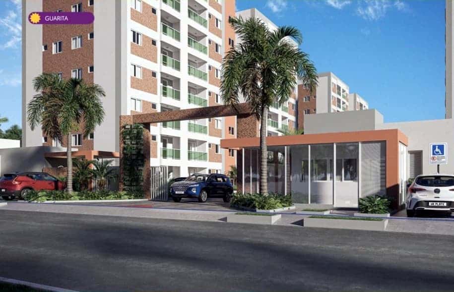 Entrada principal do condomínio Viver Aruana com guarita envidraçada e portão de acesso para veículos.