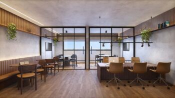 Espaço de coworking do Residencial Ilha de Maui com estações de trabalho, salas de reunião envidraçadas, cadeiras executivas e decoração moderna.