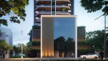 Perspectiva da fachada frontal do NEST Rio Vermelho, com entrada imponente, design contemporâneo em vidro e detalhes arquitetônicos sofisticados.