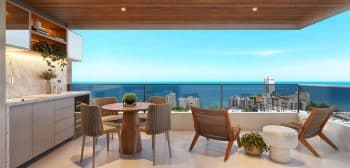 Perspectiva da varanda gourmet do apartamento 3 quartos no NEST Rio Vermelho, com vista panorâmica para o mar de Salvador.
