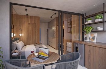 Studio do Easy São Lázaro em Salvador, com quarto, cozinha compacta, varanda integrada e decoração moderna em madeira e tons neutros.