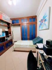 Quarto do apartamento usado 3 quartos no Garcia, em Salvador, com cama, armários planejados em madeira, prateleiras e espaço para home office.