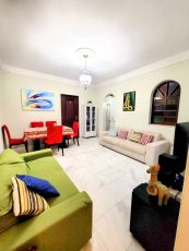 Sala do apartamento usado 3 quartos no Garcia, em Salvador, com sofás, mesa de jantar, piso em mármore claro e decoração moderna.