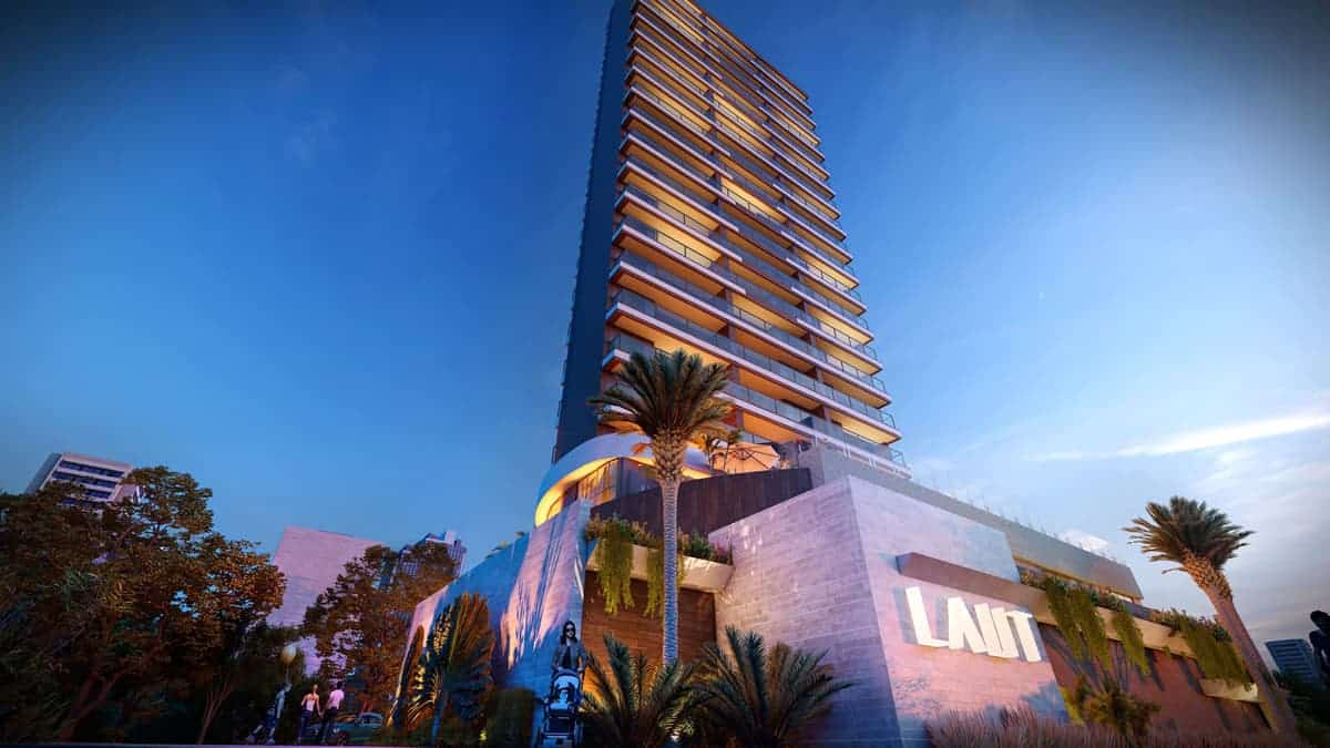 Fachada moderna do edifício Laut Jaguaribe em Salvador, com design contemporâneo, iluminação arquitetônica e paisagismo tropical.