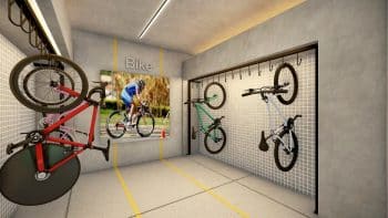 Bicicletário do Laut Jaguaribe com suportes verticais para bicicletas, iluminação embutida e design contemporâneo em concreto e pastilhas brancas.