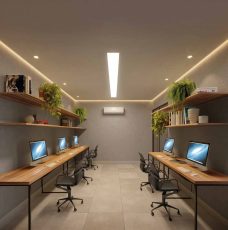 Coworking do Residencial Florença com mesas de madeira, computadores e iluminação moderna em ambiente climatizado.