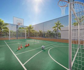 Quadra poliesportiva do Lumio Jardim Apipema em Salvador, com traves, cestas de basquete, bola de futebol e cercado de segurança.