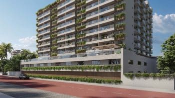 Fachada lateral do Gal Urban Beach Living em Pituaçu Salvador, com varandas verdes, pavimento elevado e arquitetura moderna