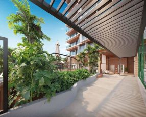 Acesso ao lobby do Lumio Jardim Apipema em Salvador, com pergolado, paisagismo tropical e fachada moderna com vidro e madeira.