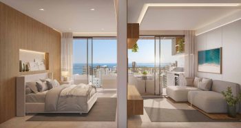 Suíte master e living do Lumio Jardim Apipema em Salvador (Aptos 101 a 2201, 105 a 2205), com vista para o mar, varanda e decoração sofisticada.