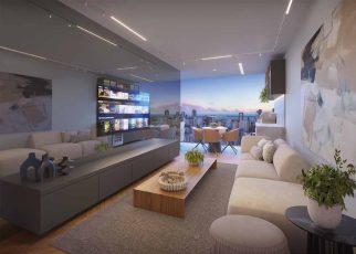 Varanda gourmet e living integrado do Lumio Jardim Apipema em Salvador, com vista para o mar, sofá, mesa de jantar e decoração moderna.