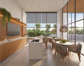 Lounge gourmet do Lumio Jardim Apipema em Salvador, com cozinha moderna, mesas de jantar e vista para área externa com vegetação.