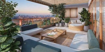 Sky lounge do Vivid Pituba com sofás, pergolado, plantas e vista panorâmica da cidade ao pôr do sol