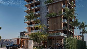 Fachada do Yu Corsário Smart Hub com varandas amplas, paisagismo tropical e arquitetura moderna na nova orla de Salvador.