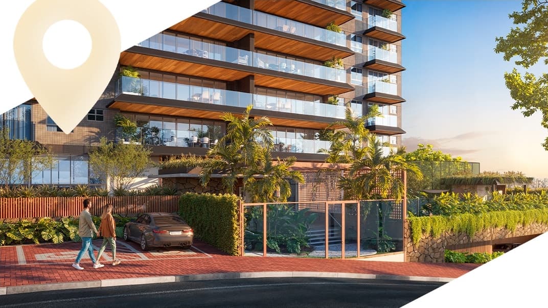 Entrada principal do condomínio ÉPICO no Caminho das Árvores, com fachada contemporânea, paisagismo integrado e acesso residencial em Salvador