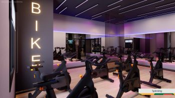 Sala de spinning do LeVille Residence com bicicletas ergométricas, espelhos amplos e iluminação moderna em tons de LED.