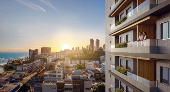 Vista da cidade de Salvador ao pôr do sol a partir do House Macapá 211 em Ondina, com varandas e prédios ao redor