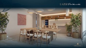 Espaço gourmet do Flamiano Costa com mesa ampla, cozinha equipada e decoração moderna na Vila Laura