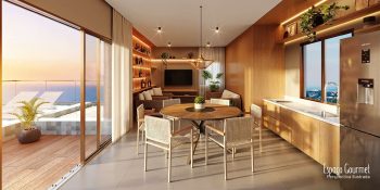Espaço gourmet do Blue Sea Smart Living com mesa de jantar, cozinha equipada e varanda com vista para o mar